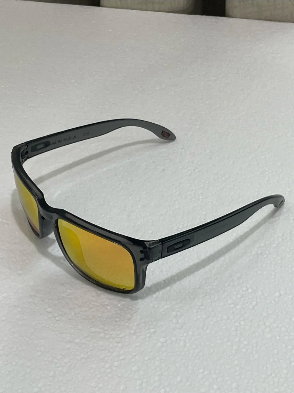 Oakley Translucent Black Frame Sunglasses with Yellow Mirrored Lenses